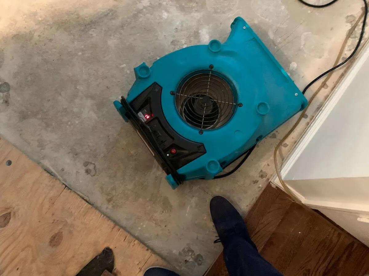 Air mover drying subfloor during Commercial Water Damage Restoration in Janesville